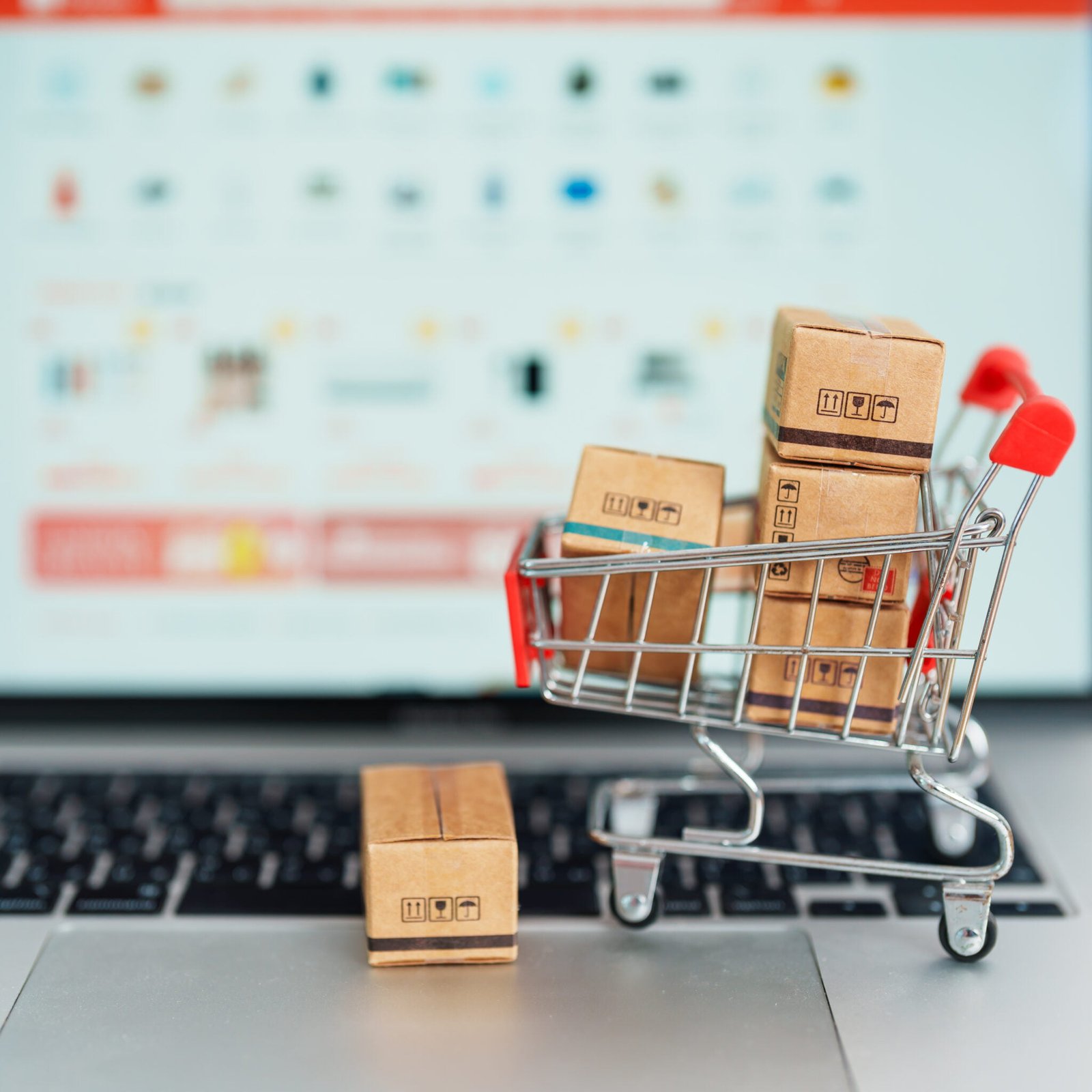 Boxes with shopping cart on a laptop computer. online shopping,